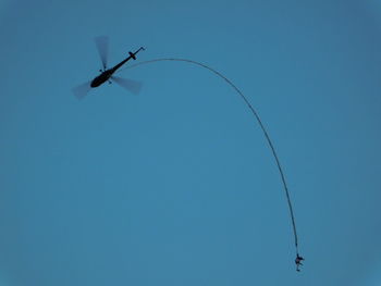 Low angle view of helicopter flying in sky