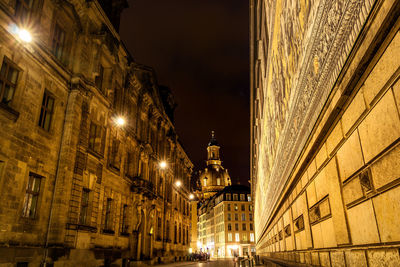 Illuminated city against sky at night