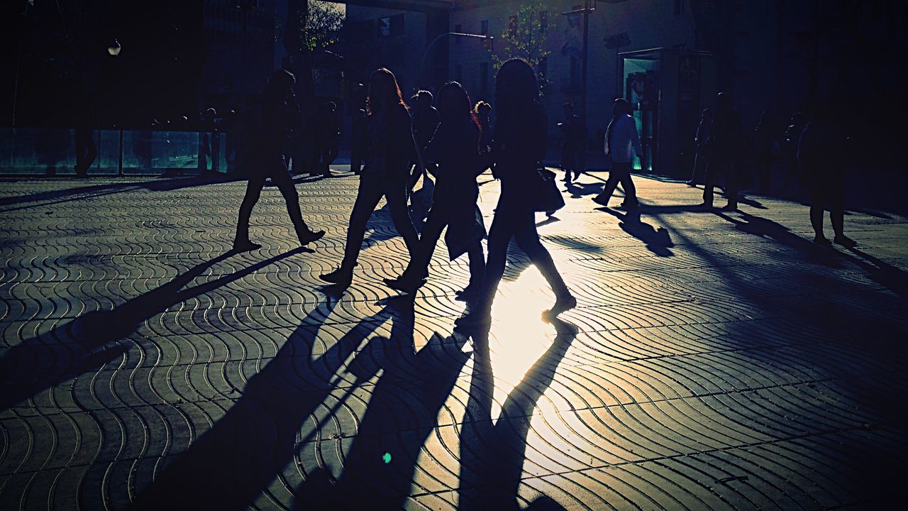 sunlight, real people, shadow, medium group of people, men, lifestyles, outdoors, day, women, full length, city, people