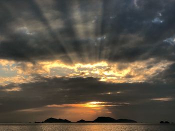 Scenic view of dramatic sky over sea during sunset