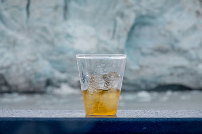 Close-up of drink on railing