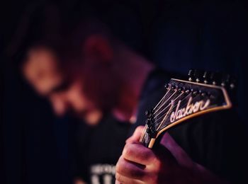 Close-up of hand holding guitar