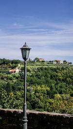 Street light against sky in city