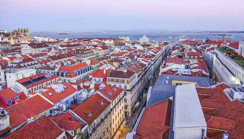 High angle view of townscape by sea against sky