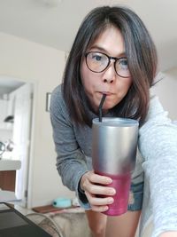 Portrait of woman drinking glass