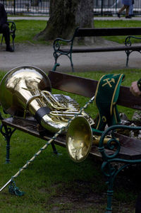 Close-up of empty bench in park