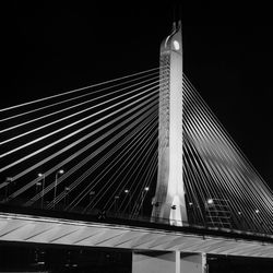 Low angle view of illuminated bridge against sky at night