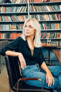 Young woman sitting on book