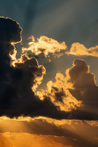 View of sky as sun sets behind the clouds