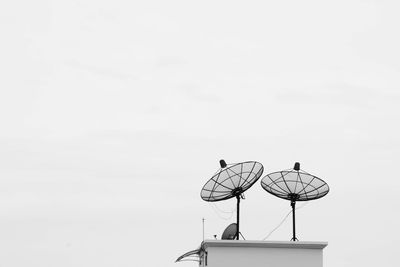 Low angle view of communications tower against sky