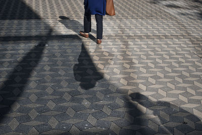 Low section of person walking on footpath