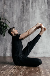 A man engaged in yoga and meditation, performing asanas