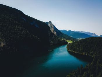 Scenic view of lake against clear blue sky