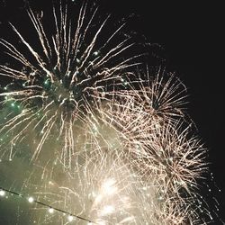 Low angle view of firework display at night