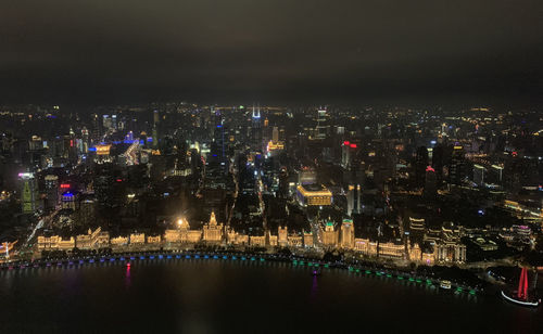 High angle view of illuminated buildings in city at night