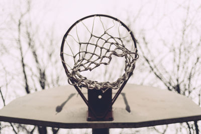 Close-up of basketball hoop against sky