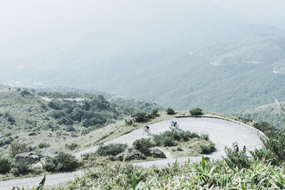 High angle view of people riding bicycles on mountain road