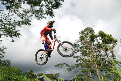 Man riding bicycle against sky