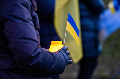 Ukrainian flags, candles and torches in the hands of protesters at the rally stand with ukraine