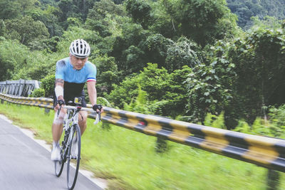 Man riding bicycle on road