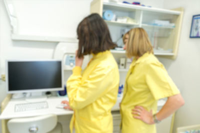 Rear view of woman using laptop