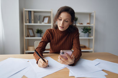 Portrait of boy studying at desk in office