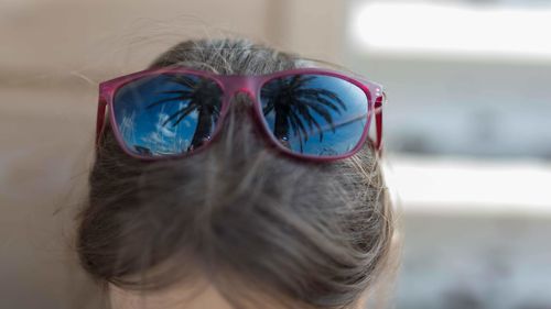 Close-up portrait of woman wearing sunglasses