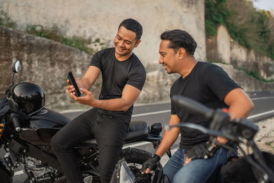 Portrait of senior man riding motorcycle on road