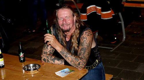 Portrait of man drinking alcohol while sitting in restaurant