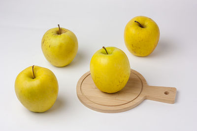 Close-up of apples on table against white background