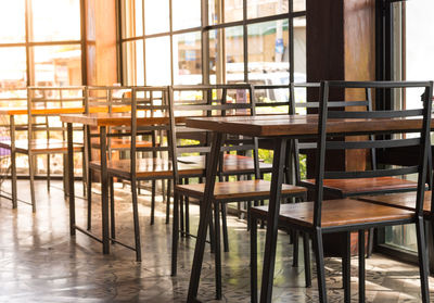 Empty chairs and tables in building