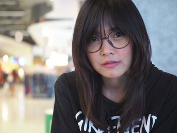 Close-up portrait of woman at shopping mall