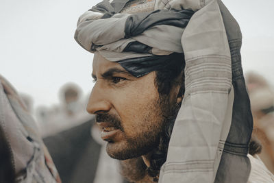 Close-up of man looking away standing outdoors