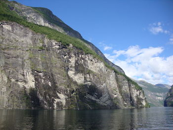 Scenic view of sea and mountains against sky