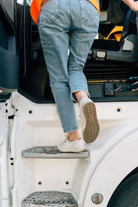 Low section of woman washing car