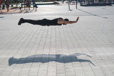 Low section of man walking on street