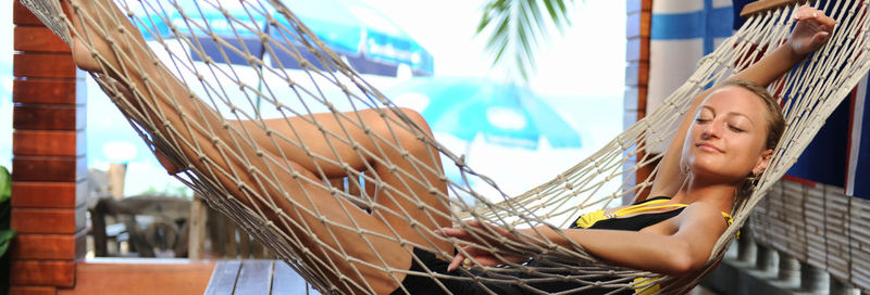 Woman relaxing in hammock