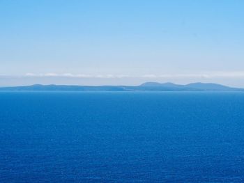 Scenic view of sea against blue sky