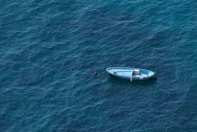 High angle view of boat sailing in calm blue sea