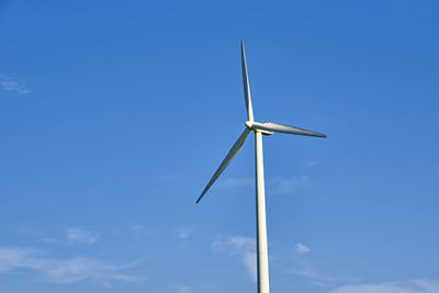 Wind turbine against blue sky. wind power energy concept. renewable energy for climate protection