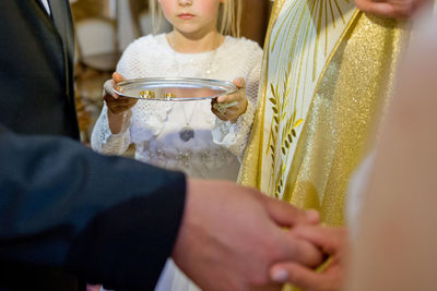 Midsection of woman holding hands