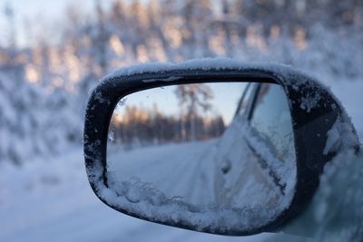 Close-up of snow on side-view mirror