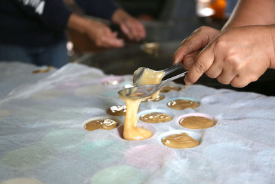 Midsection of person preparing food on table