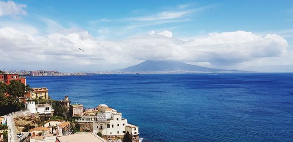 High angle view of townscape by sea against sky