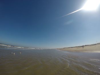 Scenic view of sea against sky on sunny day