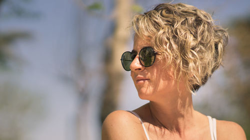 Close-up of woman wearing sunglasses while looking away