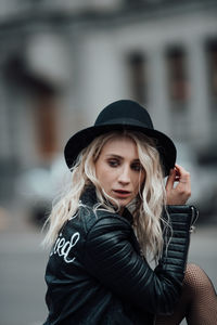 Portrait of beautiful young woman wearing hat