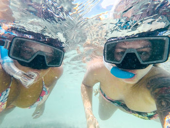 Portrait of female friends snorkeling in sea