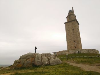 Low angle view of man standing on rock