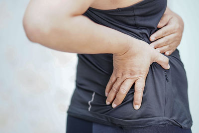 Midsection of woman standing on hand